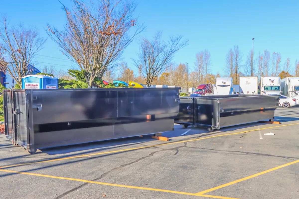 Professional dumpster rental service with roll-off container on residential driveway in Tabernacle